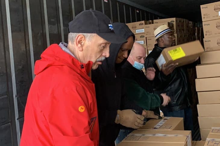 KAF Food Bank Volunteers at Work Loading Frozen Foods into Reefers